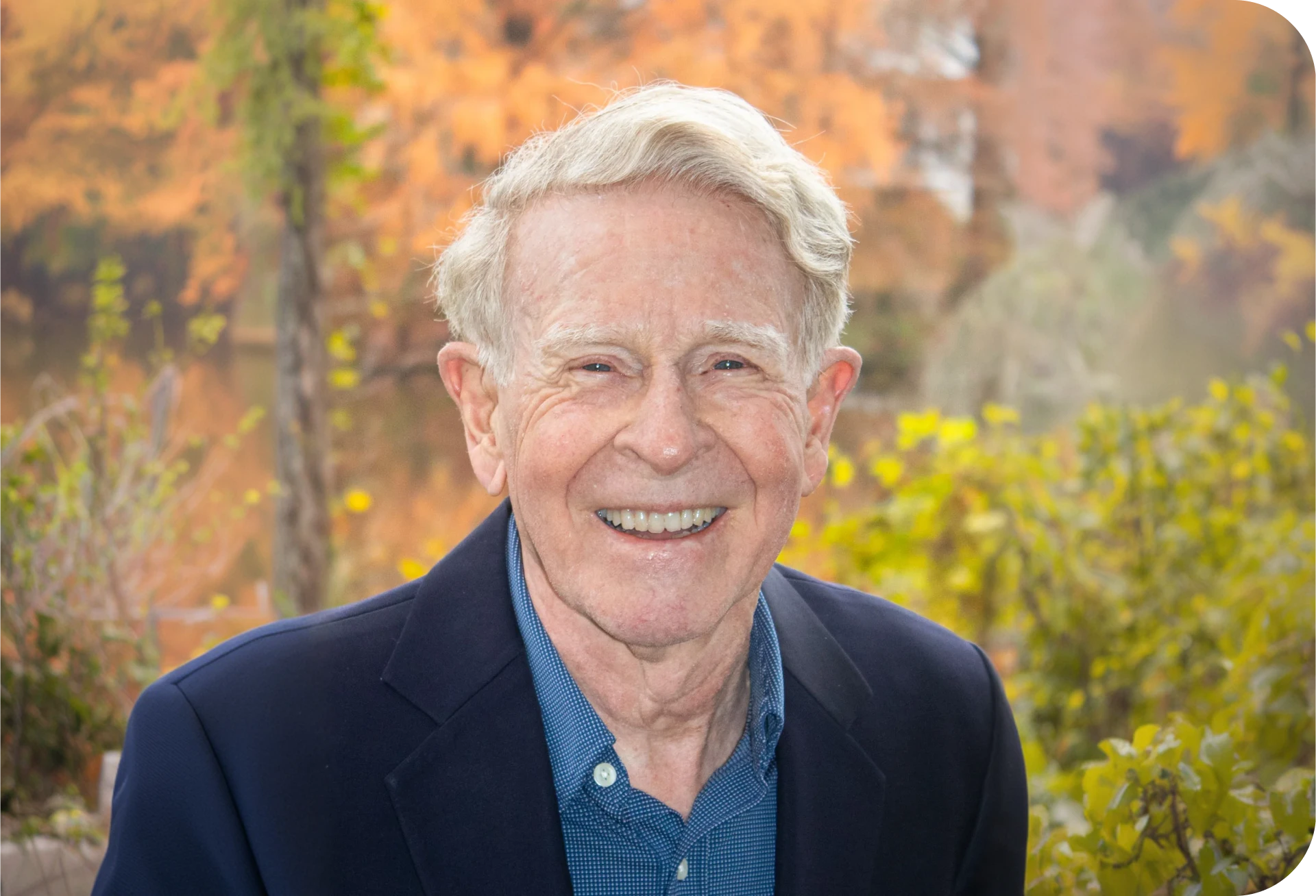 Senior man in nature with colorful leaves